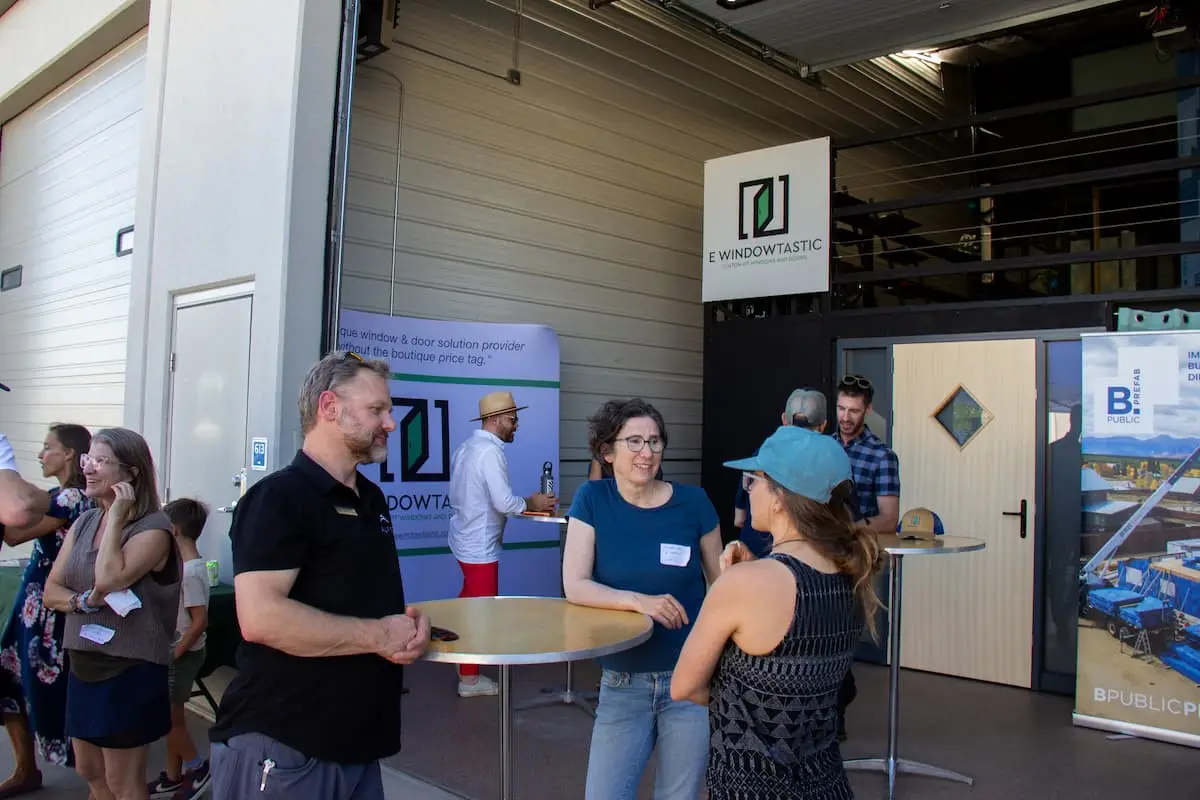 Guests socializing at an E Windowtastic happy hour in the showroom